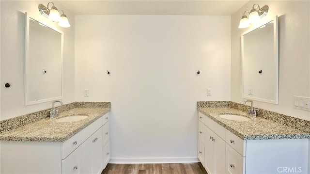 bathroom with hardwood / wood-style floors and vanity