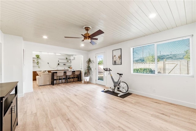 workout area featuring ceiling fan and light hardwood / wood-style flooring