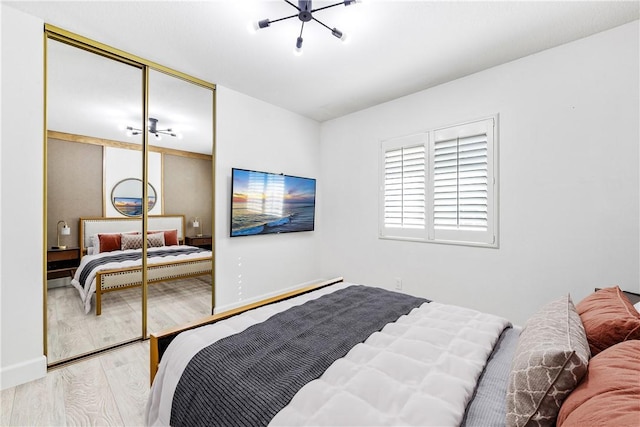 bedroom with a closet and light hardwood / wood-style floors