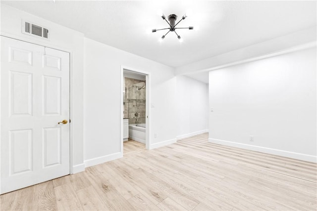 empty room with light hardwood / wood-style flooring