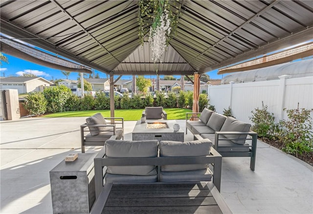 view of patio featuring a gazebo and an outdoor living space with a fire pit