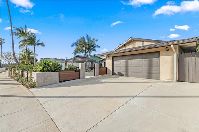 view of front of house with a garage and a gazebo