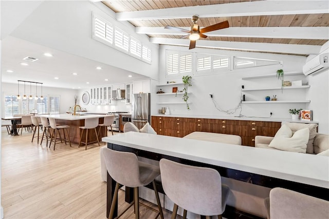 dining area with sink, wood ceiling, vaulted ceiling with beams, light hardwood / wood-style floors, and a wall mounted AC