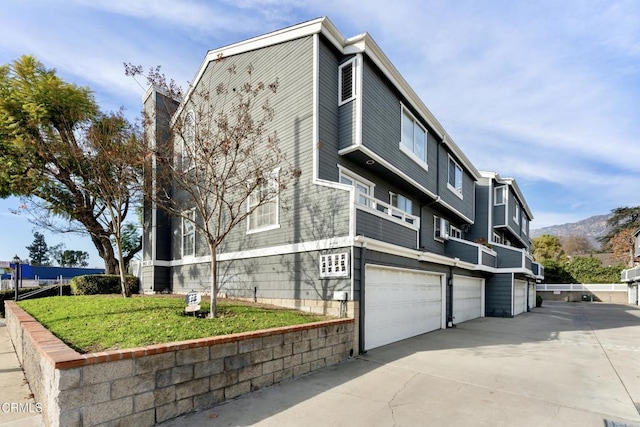 view of home's exterior featuring a garage and a mountain view