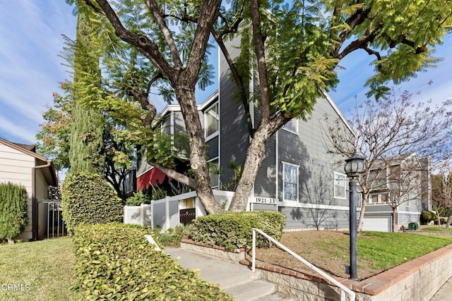 view of home's exterior featuring a garage and a yard