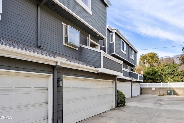 view of side of property with central AC unit and a garage