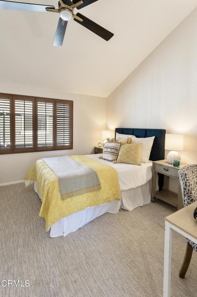 bedroom with vaulted ceiling, light colored carpet, and ceiling fan