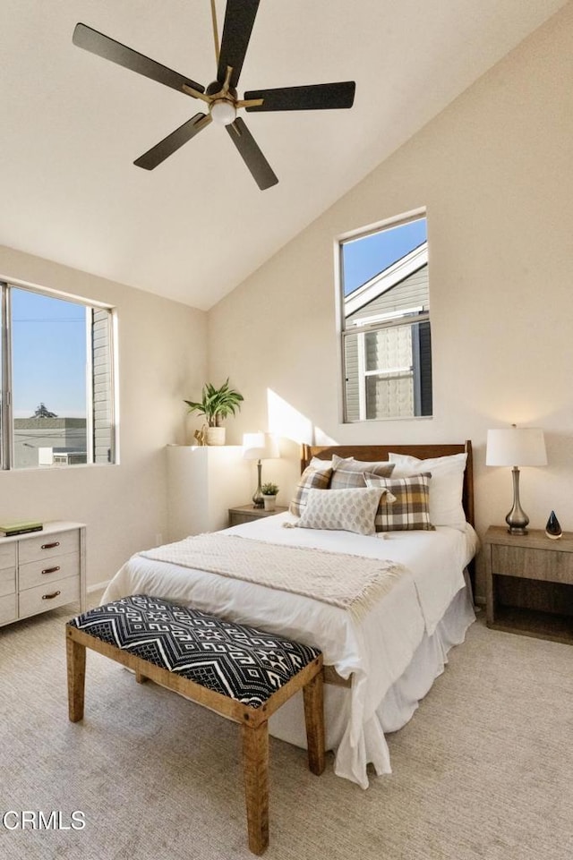 bedroom featuring multiple windows, lofted ceiling, and carpet