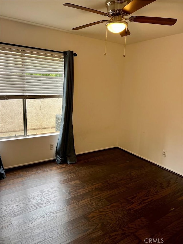 unfurnished room featuring ceiling fan and dark hardwood / wood-style flooring