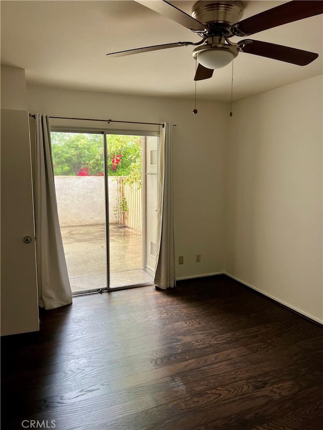 empty room featuring ceiling fan and dark hardwood / wood-style floors