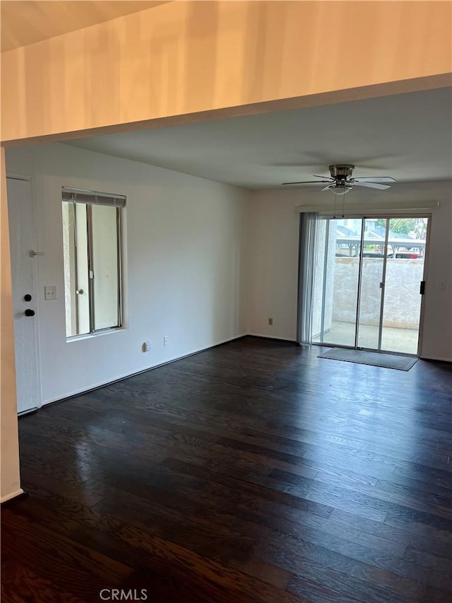 unfurnished room with dark hardwood / wood-style flooring and ceiling fan