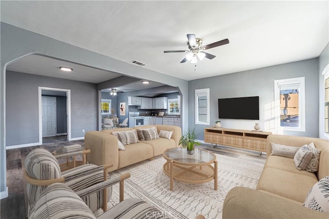 living room featuring ceiling fan and hardwood / wood-style flooring