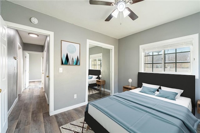 bedroom with a closet, ceiling fan, and dark wood-type flooring