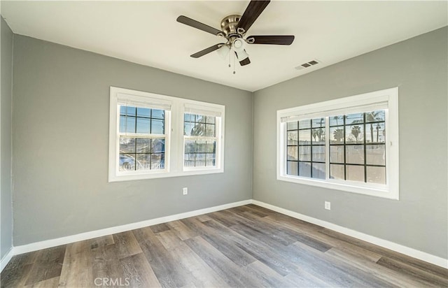 spare room with ceiling fan and hardwood / wood-style floors