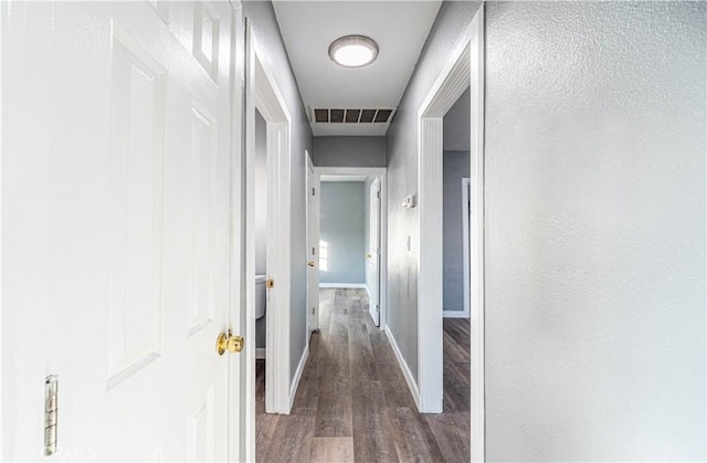 hall with dark hardwood / wood-style flooring