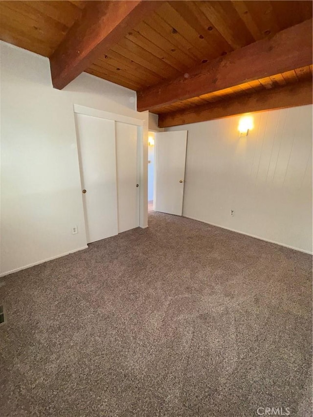 interior space featuring wooden ceiling, carpet floors, and beamed ceiling