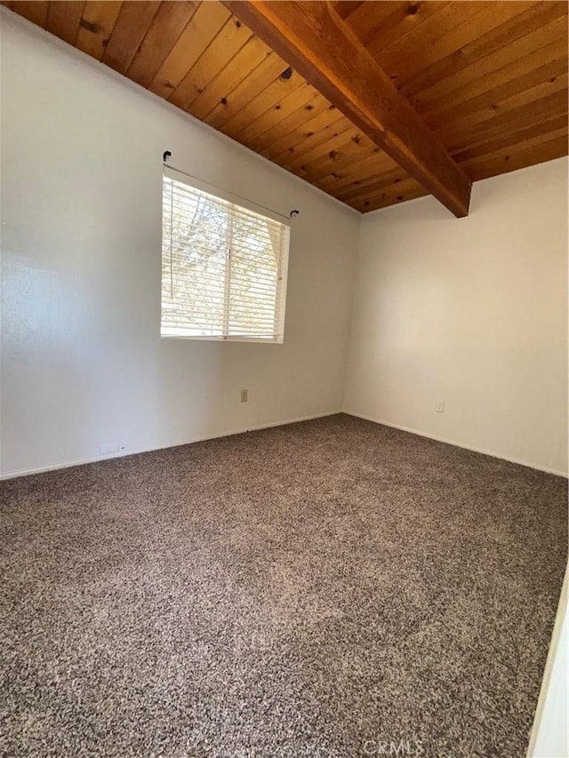 empty room featuring wood ceiling, beam ceiling, and carpet floors