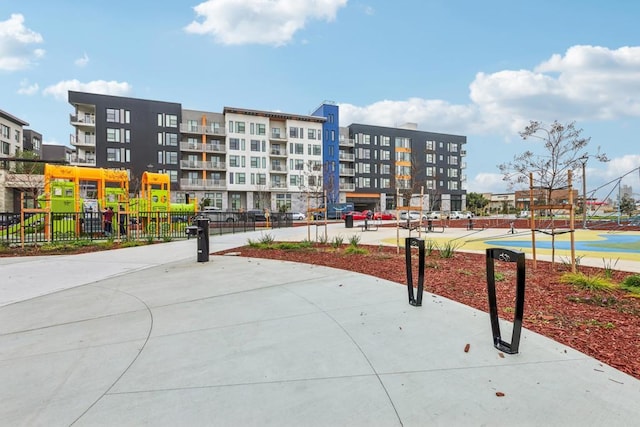 view of home's community featuring a playground and tennis court