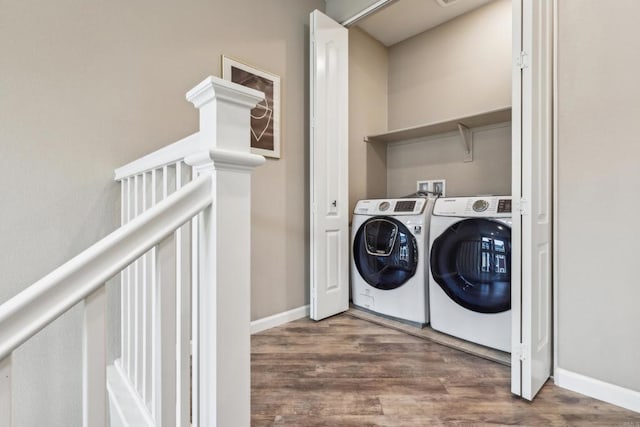 washroom featuring washer and clothes dryer and dark hardwood / wood-style flooring