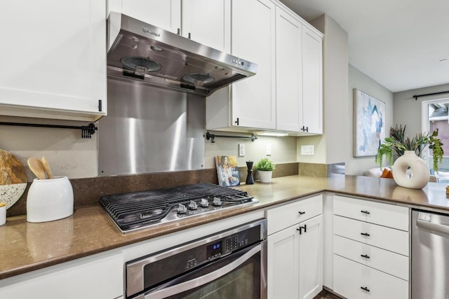 kitchen with white cabinets, dark stone countertops, and appliances with stainless steel finishes