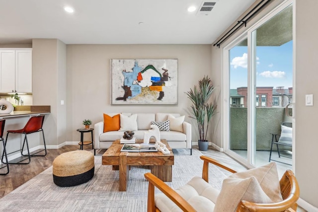 living area with hardwood / wood-style floors