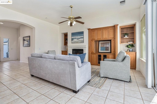 tiled living room with ceiling fan