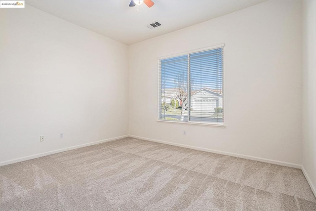 empty room featuring carpet flooring and ceiling fan