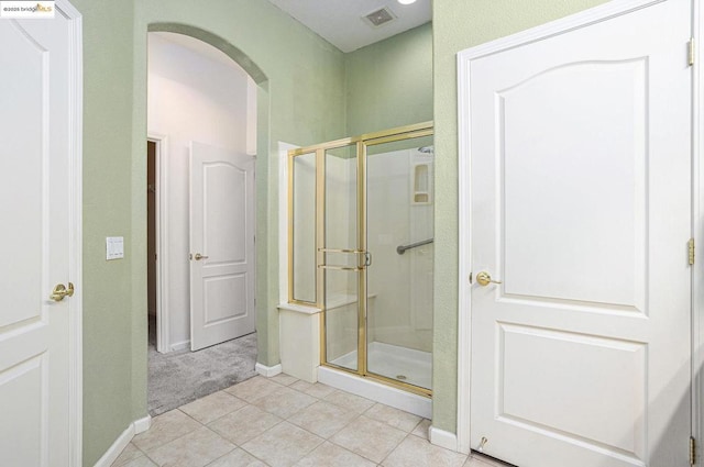 bathroom with tile patterned floors and walk in shower