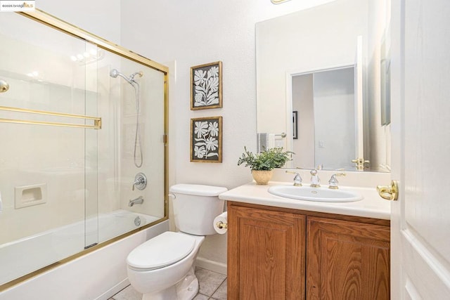 full bathroom featuring combined bath / shower with glass door, toilet, tile patterned flooring, and vanity