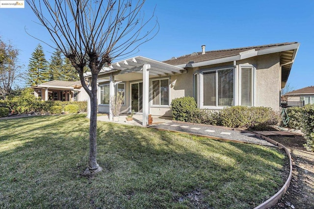 back of property with a pergola and a yard