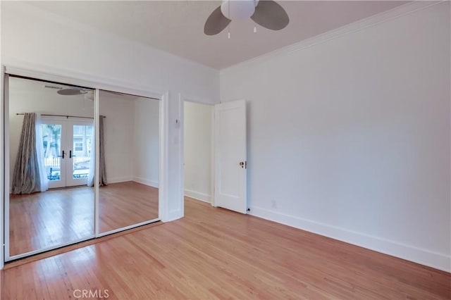 unfurnished bedroom featuring light wood-type flooring, a closet, ceiling fan, and french doors