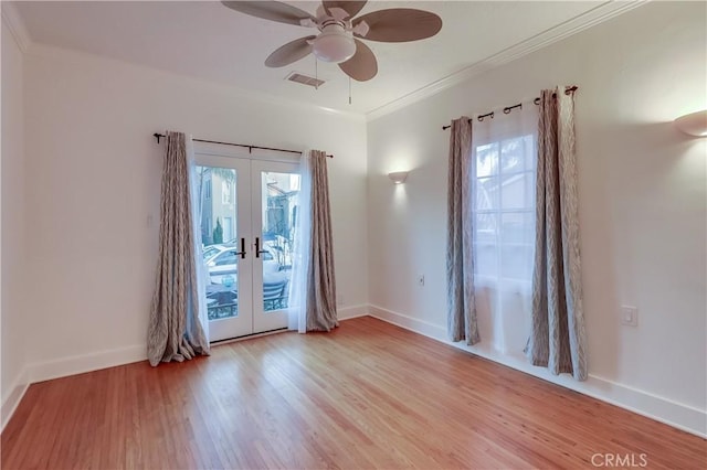 spare room with french doors, crown molding, and light hardwood / wood-style floors