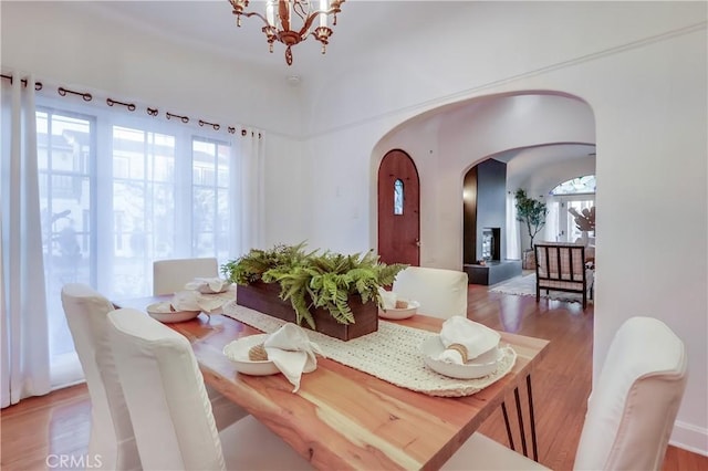 dining room with wood-type flooring and a notable chandelier