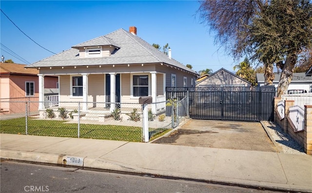 bungalow-style house featuring a porch and a front lawn