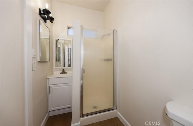 bathroom featuring vanity, toilet, walk in shower, and wood-type flooring