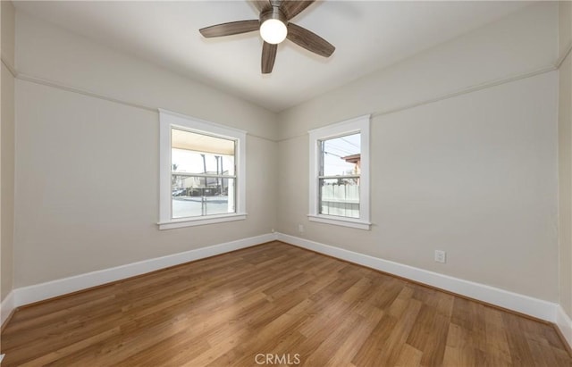 spare room with wood-type flooring and ceiling fan