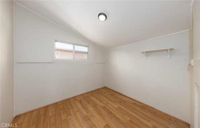 additional living space featuring light wood-type flooring and lofted ceiling