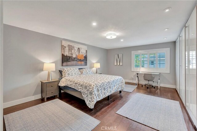 bedroom with dark hardwood / wood-style floors