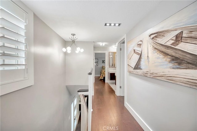 hall featuring a notable chandelier and dark hardwood / wood-style floors