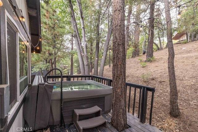 wooden deck featuring a hot tub