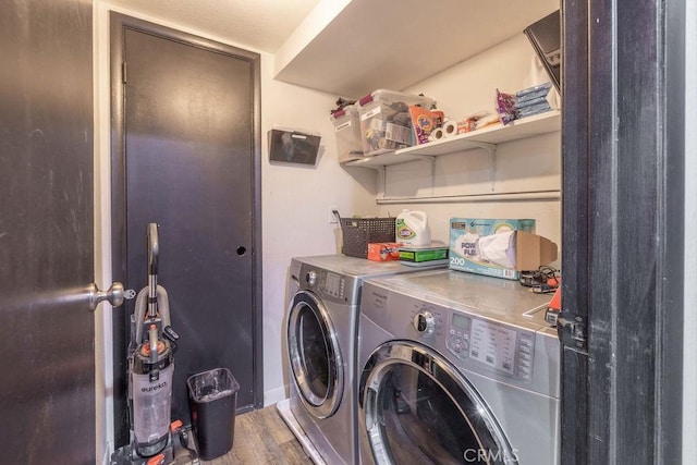 washroom with hardwood / wood-style floors and independent washer and dryer