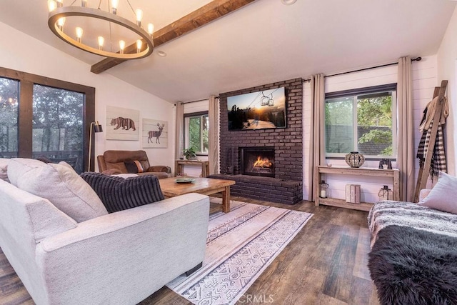 living room with a healthy amount of sunlight, vaulted ceiling with beams, dark hardwood / wood-style floors, and a fireplace