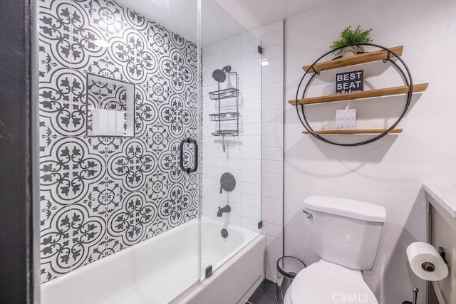 bathroom featuring toilet and enclosed tub / shower combo