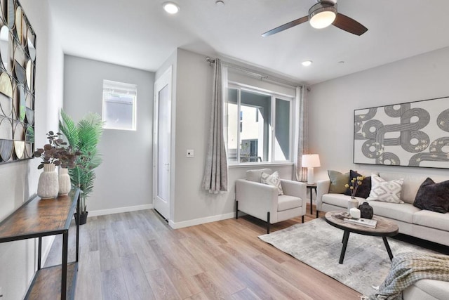 living room featuring ceiling fan and light hardwood / wood-style flooring