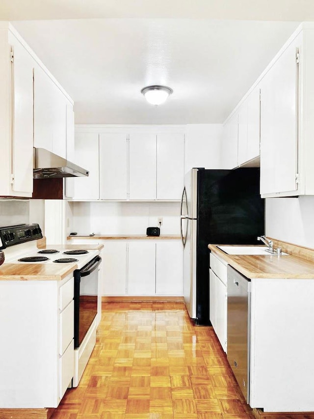 kitchen featuring white cabinets, light parquet flooring, and stainless steel appliances