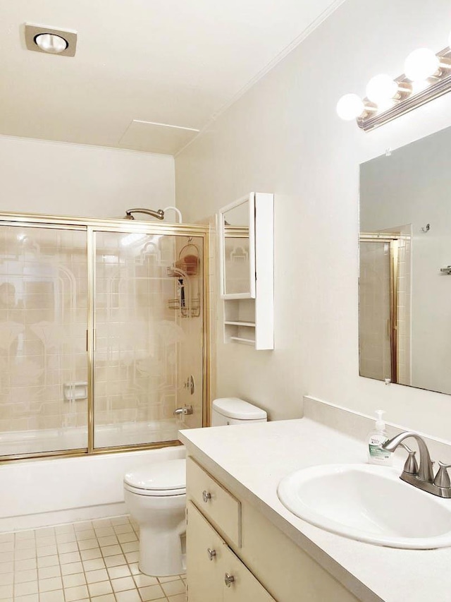 full bathroom featuring enclosed tub / shower combo, toilet, vanity, and tile patterned flooring