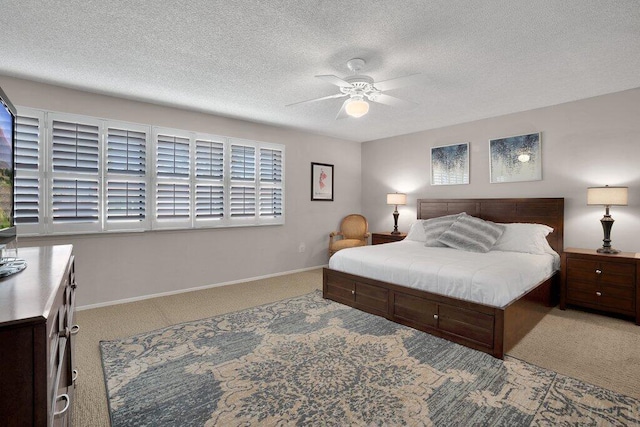 bedroom featuring ceiling fan, carpet flooring, and a textured ceiling