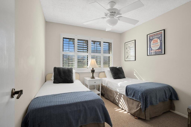 carpeted bedroom with a textured ceiling and ceiling fan