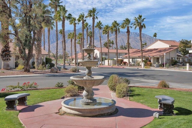 view of property's community featuring a mountain view and a lawn