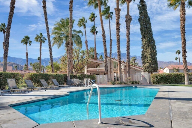 view of swimming pool featuring a mountain view and a patio area